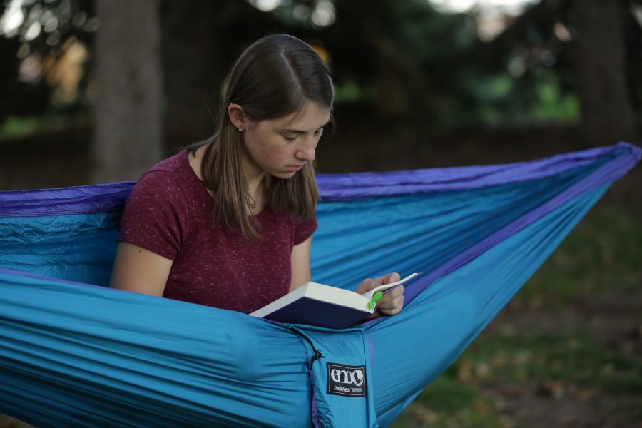 Bailey Richards, a first-year student at Colorado State University, reads while sitting in her hammock near the Lagoon on October 18, 2017. (Forrest Czarnecki | The Collegian)
