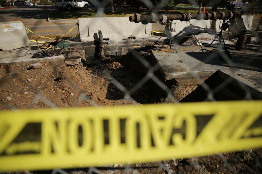 Construction workers and equipment is pictured along West Plum Street near the Colorado State University Transit Center on Tuesday morning. Workers were replacing and rerouting a condensation line underneath the roadway. (Forrest Czarnecki | The Collegian)