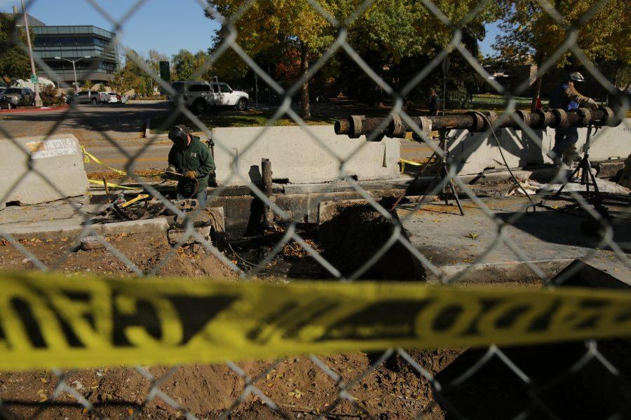 Construction workers and equipment is pictured along West Plum Street near the Colorado State University Transit Center on Tuesday morning. Workers were replacing and rerouting a condensation line underneath the roadway. (Forrest Czarnecki | The Collegian)