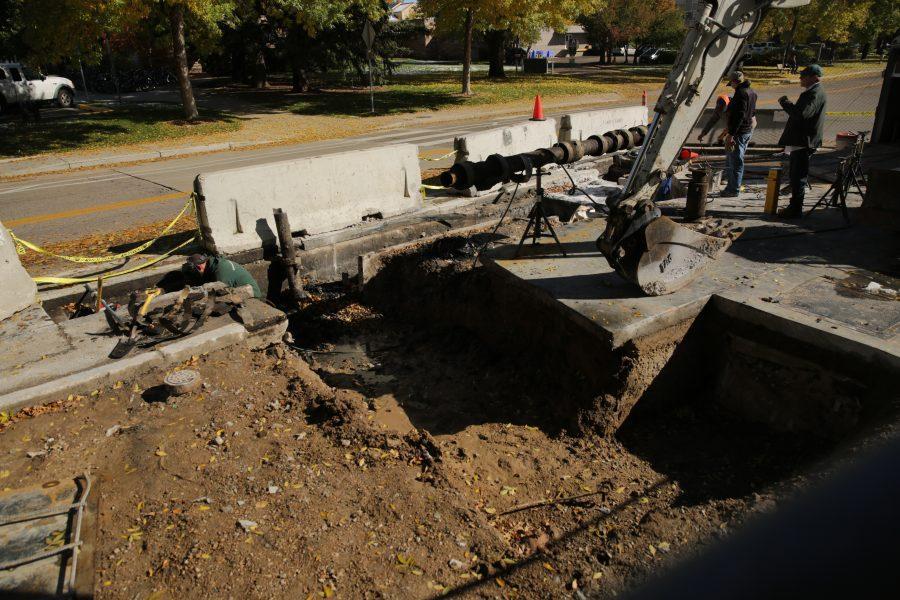 Construction workers and equipment is pictured along West Plum Street near the Colorado State University Transit Center on Tuesday morning. Workers were replacing and rerouting a condensation line underneath the roadway. (Forrest Czarnecki | The Collegian)