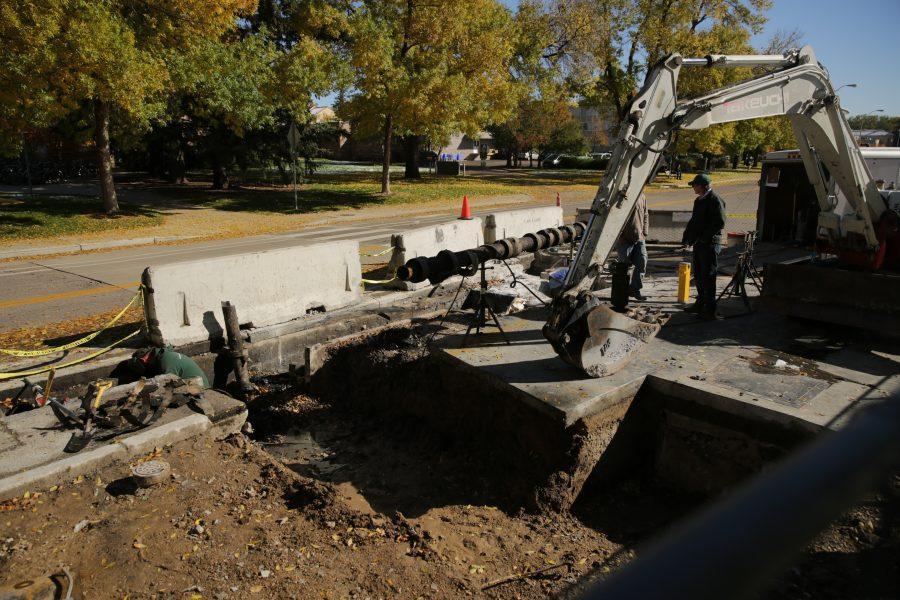 Construction workers and equipment is pictured along West Plum Street near the Colorado State University Transit Center on Tuesday morning. Workers were replacing and rerouting a condensation line underneath the roadway. (Forrest Czarnecki | The Collegian)