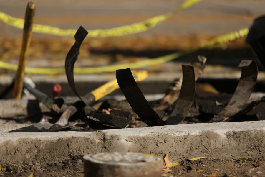 Metal strips and construction equipment are strewn around a construction zone along West Plum Street near the Colorado State University Transit Center on Tuesday morning. Workers were replacing and rerouting a condensation line underneath the roadway. (Forrest Czarnecki | The Collegian)