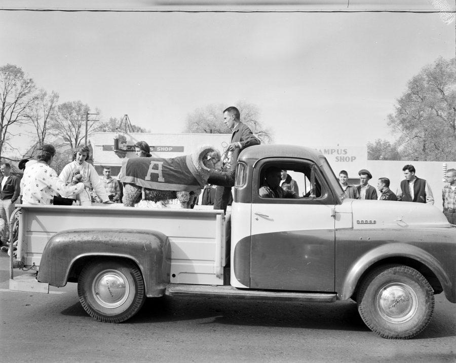 Students in pajamas sit in the back of a Dodge truck with the Aggie ram in the pajama parade before Homecoming 1956 game against Montana. (Photo courtesy of University Historic Photograph Collection)