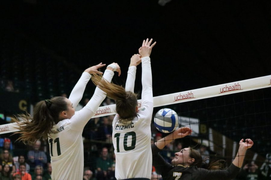 Paulina Hougaard-Jensen and teammate Sanja Cizmic go up and get a block during their win against Wyoming in the Border War. (Joe Oakman | Collegian) 