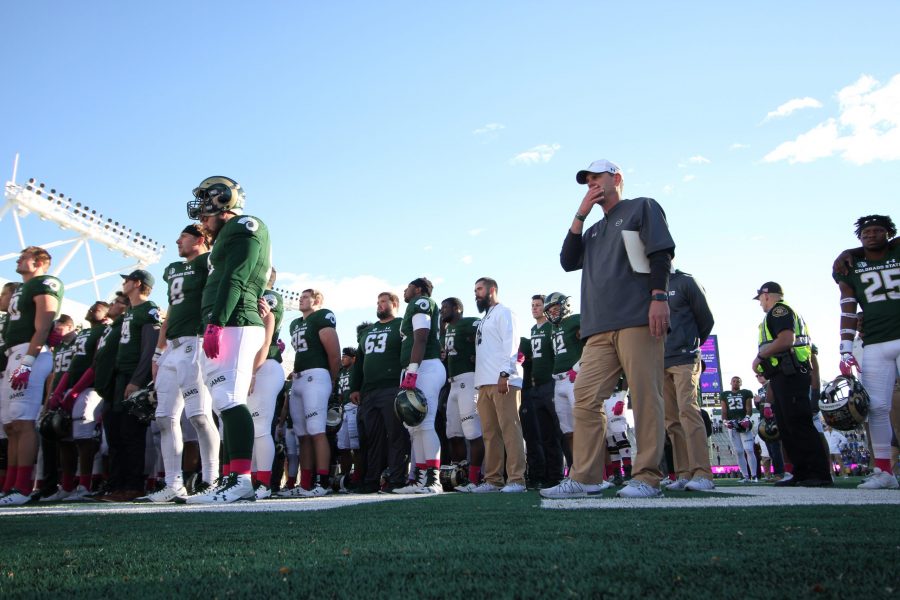 Mike Bobo stands with the football team while they sing the alma mater with the CSU marching band. Rams were defeated 45-28 by Air Force academy. (Tony Villalobos May | Collegian)