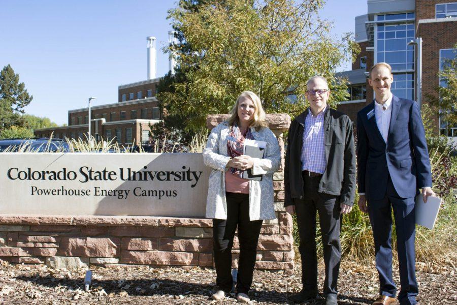 District director for Congressman Polis Mara Brosy-Wiwchar, climate scientist and professor Scott Denning, and director of Environment Colorado Garrett-Garner-Wells pose in front of the Colorado State University Powerhouse Energy Campus. They held a press conference Thursday highlighting a plan to guide campuses towards 100 percent renewable energy. (Brooke Buchan | Collegian)