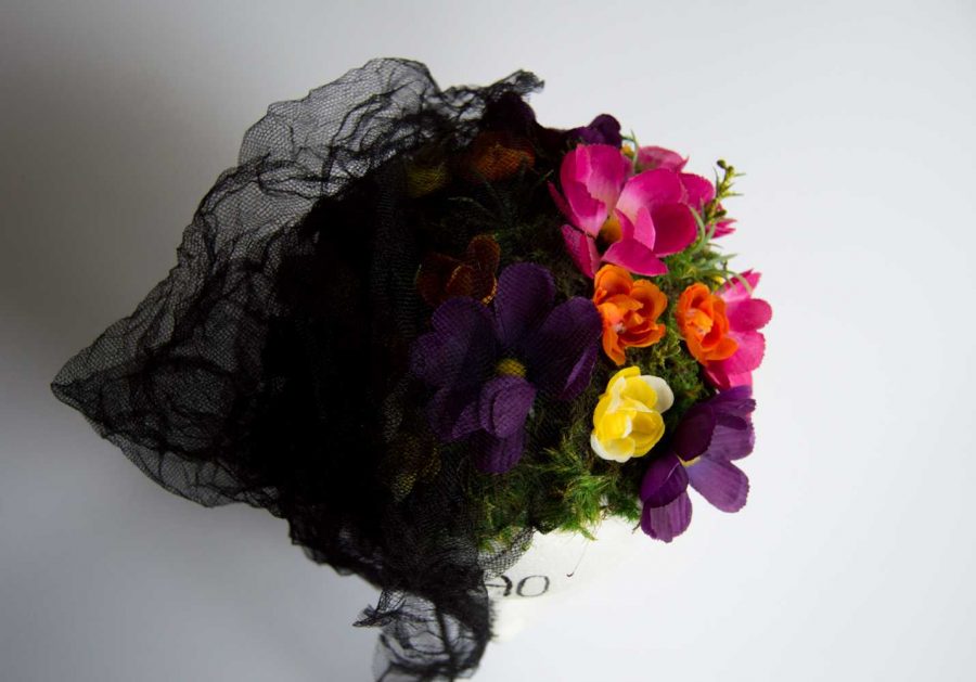 Depression is symbolized in a sculpture presentation. The sculpture symbolizes the brain with a flower garden, and a black veil over half represents depression overcoming mental beauty. But, the side uncovered represents a garden of self care, love and hope. Photo illustration by Olive Ancell | Collegian