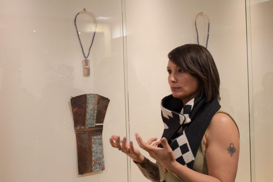 Jennifer Younger talks about her work at Forest Creatures located at the Duhesa art gallery on Tuesday, November 7, 2017. The copper piece was called Two Skins. (JuliaBailey | Collegian)