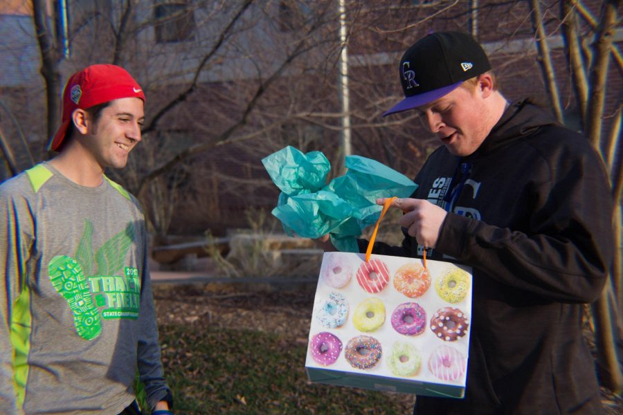 On November 14, 2017 two friends bond over a gift. Michael Hernandez gives a present to his friend Tyler Haman. (Julia Bailey | Collegian)