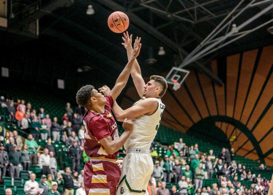 Colorado State University Sophomore Forward Nico Carvacho shoots against MCU defender Jerome LaNeir (42) during the Rams 86-75 exhibition game win. (Davis Bonner | Collegian)