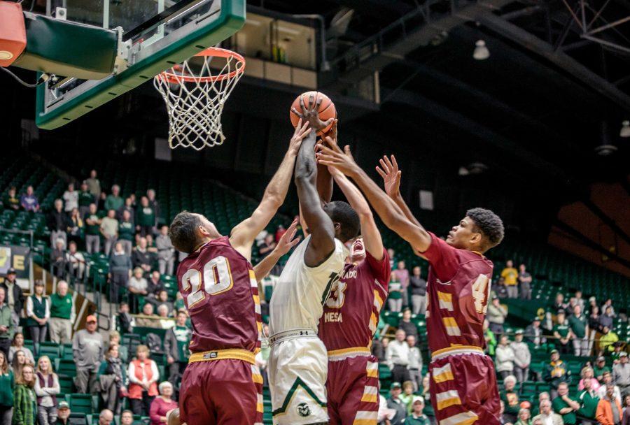 Colorado State University Senior Forward Che Bob attempts a dunk against MCU defenders during the Rams 86-75 exhibition game win Friday night. (Davis Bonner | Collegian)