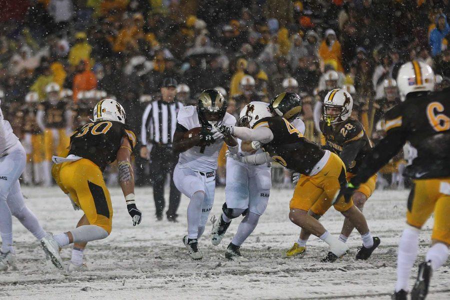 Colorado State Running Back Dalyn Dawkins moves the ball down the field during the snowy third quarter in Laramie, Wyoming on Nov. 4. (Elliott Jerge | Collegian)