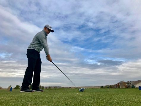 Tyler Smiens tees a ball up while out golfing on a chilly fall day in 2017. (Collegian file photo)