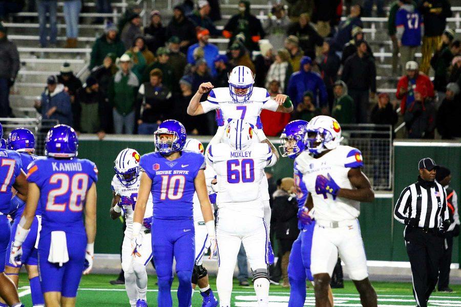 Senior quarterback Nick Stevens (7) celebrates with Trae Moxley (60) after a touchdown run during the second half against Boise State. (Javon Harris | Collegian)