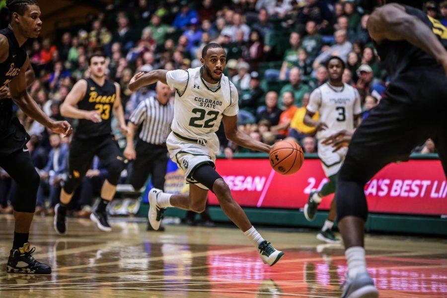 J.D. Paige (22) sprints forward with the basketball against Long Beach State on Dec. 23, 2017. (Tony Villalobos May | Collegian)