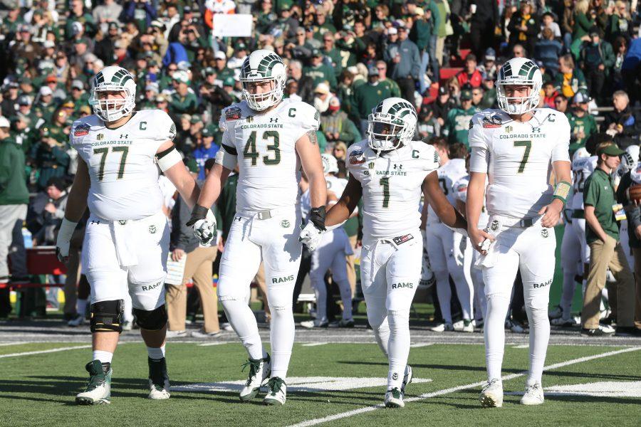 The Colorado State Captains Offensive Lineman Jake Bennett, Linebacker Evan Colorito, Runningback Dalyn Dawkins and Quarterback Nick Stevens walk out to the center of the field for the Coin Toss prior to the start of the Gildan New Mexico Bowl. (Elliott Jerge | Collegian)