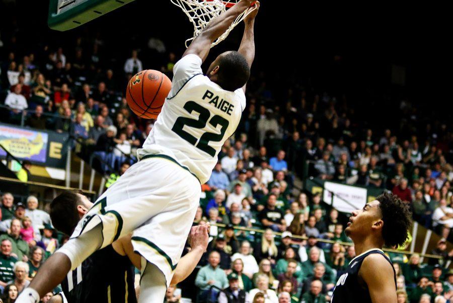 CSU guard J.D. Paige dunks over Colorado guard Lazar Nikolic in the second half of the game on Dec. 2. zThe Rams defeated the Buffaloes 72-63. (Javon Harris | Collegian)