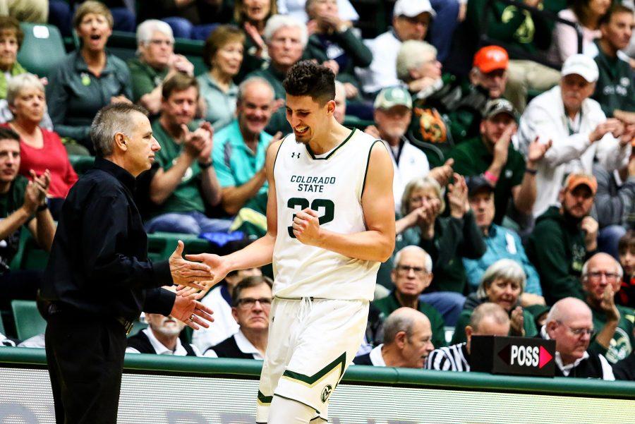 Nico Carvacho (32) celebrates with Head Coach Larry Eustachy after having a huge defensive stop against rival Colorado. (Javon Harris | Collegian)