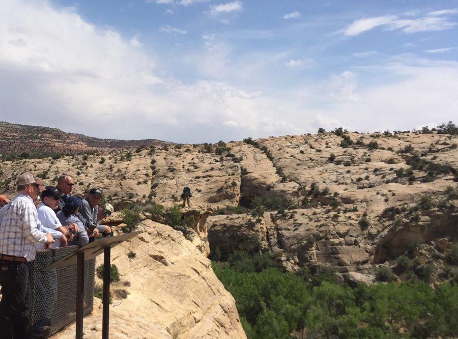 Interior Secretary Ryan Zinke, hatless and wearing sunglasses, looks at ancient native ruins in Bears Ears National Monument, Utah. (William Yardley/Los Angeles Times/TNS)