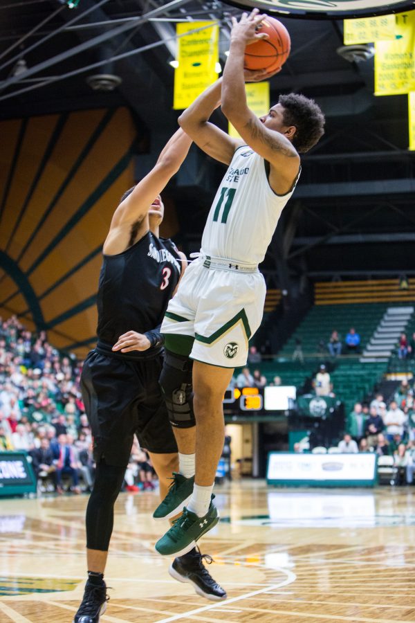 Colorado State University Junior guard Prentiss Nixon jumps up to shoot against San Diego State defender Trey Kell during the Rams 77-68 loss Tuesday night. (Davis Bonner | Collegian)