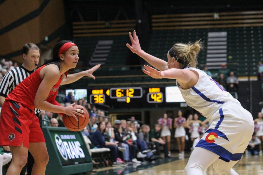 Hannah Tvrdy defends a University of New Mexico player during the State Pride game on Saturday, Jan. 27. The Rams beat the Lobos 74-71 in overtime. (Ashley Potts | Collegian)