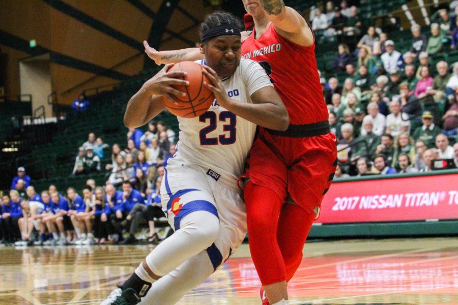 Grace Colaivalu drives to the basket, defended by a University of New Mexico player, during the State Pride game on Saturday, Jan. 27. The Rams beat the Lobos 74-71 in overtime. (Ashley Potts | Collegian)
