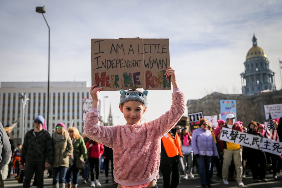 Olivia Varda, 8, holds up a homemade sign at the second annual Womens March through downtown Denver on Jan 20.  (Tony Villalobos May | Collegian
