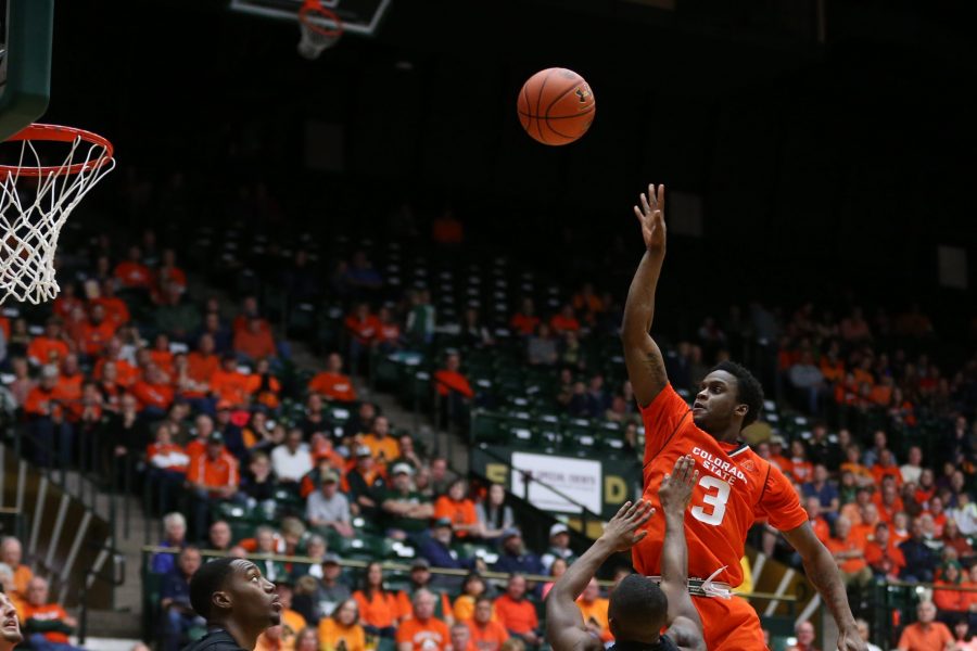 Sophomore guard Raquan Mitchell takes a shot over the defenders during the second half of action against the UNLV Rebels on Jan. 20 at Moby Arena. The Rams fell to the Rebels 79-74. (Elliott Jerge | Collegian)