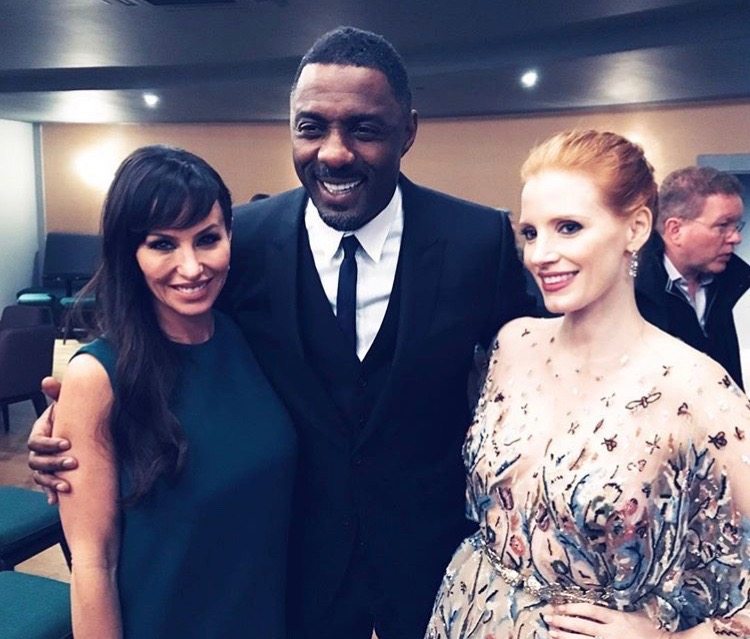 Molly Bloom (far left) stands with stars of the film Mollys Game Idris Elba (middle) and Jessica Chastain (right) (Image courtesy Molly Bloom)