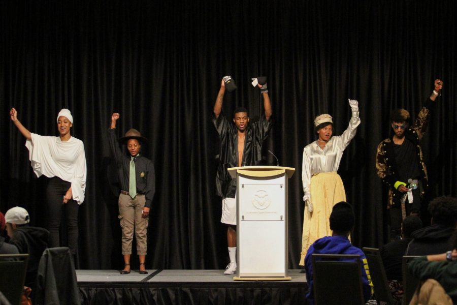 All five of the students dressed as living statues hold up their hands after their performances as part of the Black History Month Kick Off Event on Feb. 1. (Ashley Potts | Collegian)