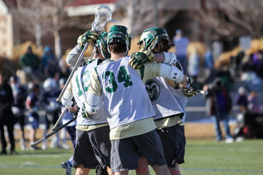 Brian McGhie (18) and Gabe Remshardt (34) celebrate with teammates after a goal against Metro State. The Rams beat the Roadrunners 18-6 in the first scrimmage of the season on Saturday, Feb. 3. (Ashley Potts | Collegian)