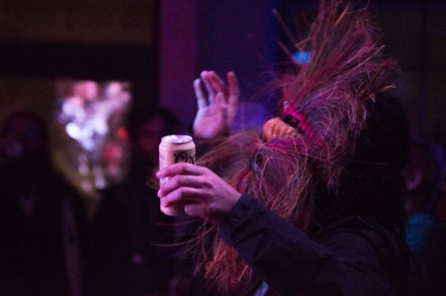 A rare breed of concert fan was found rocking out in a mask during Battle of the Bands Thursday night at the Downtown Artery. (Photo by Olive Ancell | Collegian)