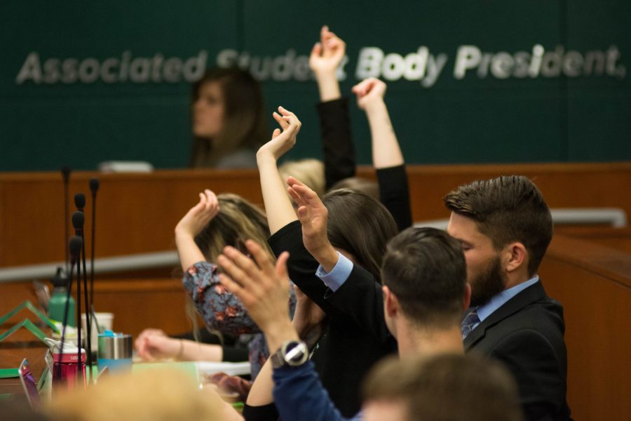 ASCSU Senators raise their hands to receive ballots for voting on Feb. 21, 2018. (Colin Shepherd | Collegian)