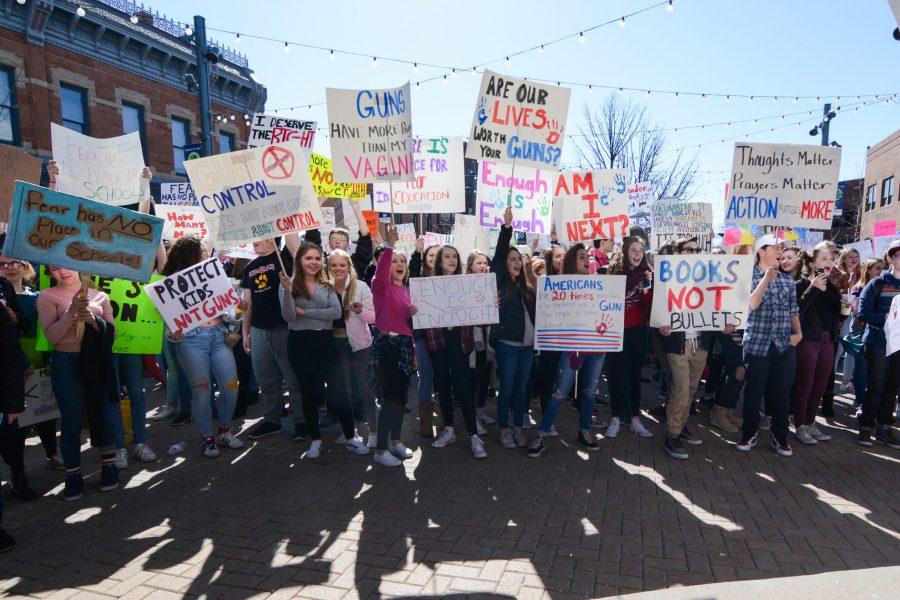 Students from the Poudre School District hold signs in Old Town Square Plaza on Feb. 27, 2018, during the Walk Out protest. The protest was held by students, parents, and community members to pay respects to the children killed in the Stoneman Douglas High School Shooting in Parkland, Florida on Feb. 14, 2018, and to request better gun safety laws and regulations. (Colin Shepherd | Collegian)