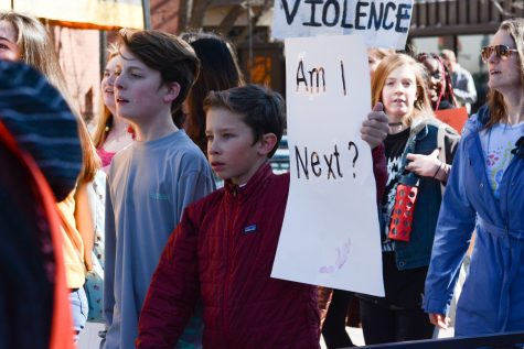 A student from the Poudre School District makes his way into Old Town Square Plaza on Feb. 27, 2018, during the Walk Out protest. The protest was held by students, parents, and community members to pay respects to the children killed in the Stoneman Douglas High School Shooting in Parkland, Florida on Feb. 14, 2018, and to request better gun safety laws and regulations. (Colin Shepherd | Collegian)