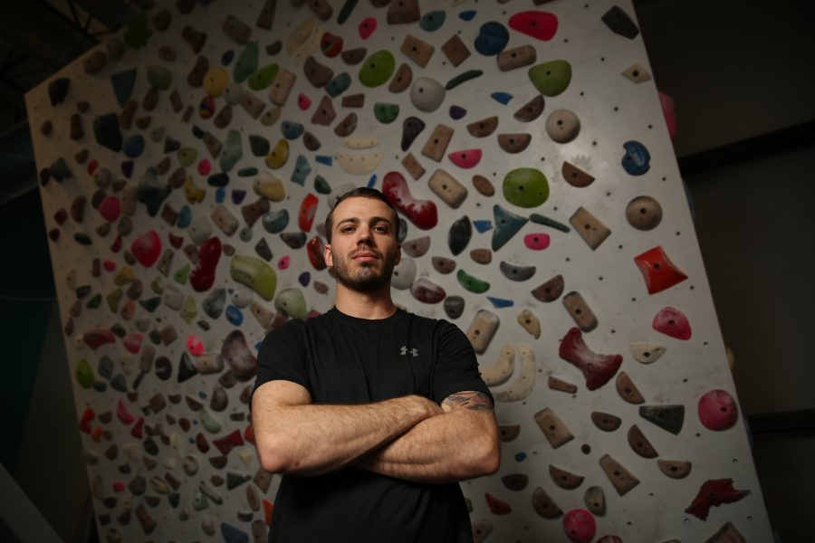 Dustin Fishman poses for a portrait at the Ascent Studio Climbing and Fitness gym in Fort Collins on Feb. 14, 2018. Fishman, who is a Marine veteran, recently competed on season 9 of American Ninja Warrior.  (Forrest Czarnecki | The Collegian)
