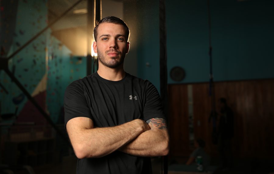 Dustin Fishman poses for a portrait at the Ascent Studio Climbing and Fitness gym in Fort Collins on Feb. 14, 2018. Fishman, who is a Marine veteran, recently competed on season 9 of American Ninja Warrior.  (Forrest Czarnecki | The Collegian)