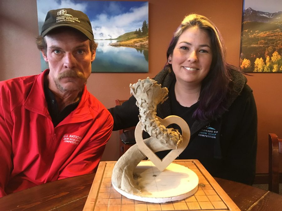 Steve Mercia, Kerri Ertman and Alex Amys (not pictured) made up Colorado Team 3 at the US National Snow Sculpting Competition. Here, Mercia and Ertman pose with the clay design of their sculpture Peace Within. Parts of the sculpture ended up being hundreds of pounds and requires patience and focus to work with. (Sarah Ehrlich | Collegian) 