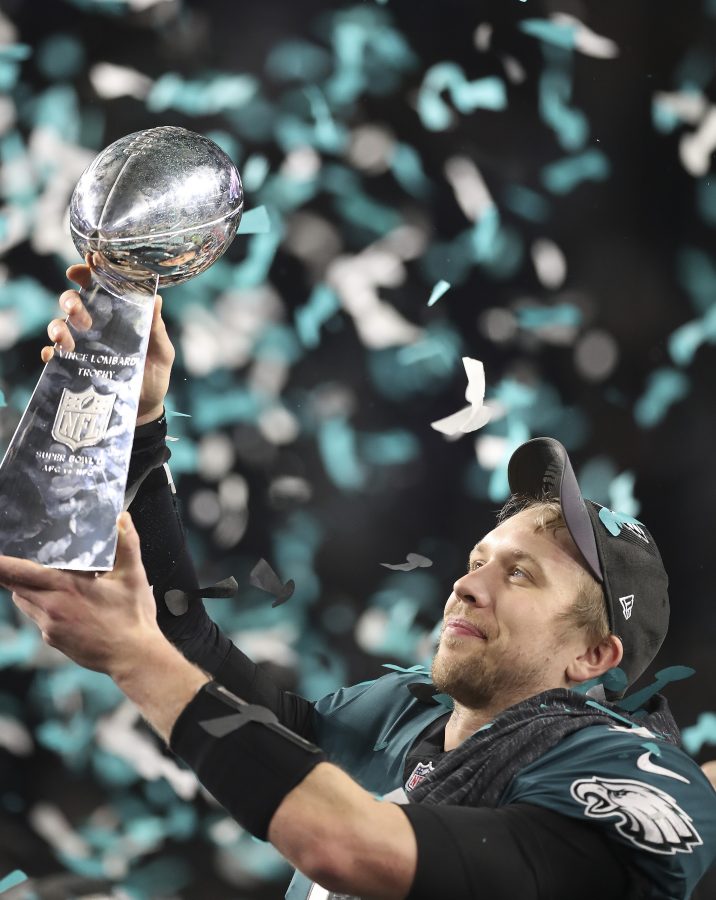 As confetti floats down at U.S. Bank Stadium, Philadelphia Eagles quarterback Nick Foles lifts up the Vince Lombardi trophy after leading his team to a 41-33 victory over the New England Patriots in Super Bowl LIIon Sunday, Feb. 4, 2018, in Minneapolis, Minn. After taking over as starter in December after Carson Wentz was injured, and facing many doubters, he was named the games MVP. (Jerry Holt/Minneapolis Star Tribune/TNS)