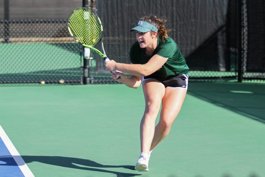 Freshman Emma Corwin hits against her oppenent from Omaha during the Rams first home matches of the season on March 3. (Ashley Potts | Collegian)