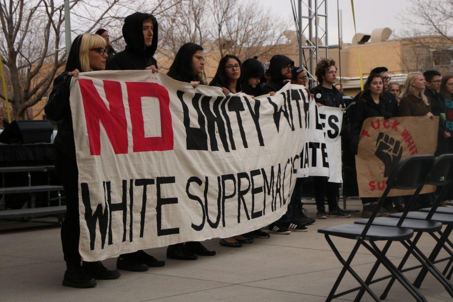 Students hold a No unity with white supremacists banner during the CSUnity rally