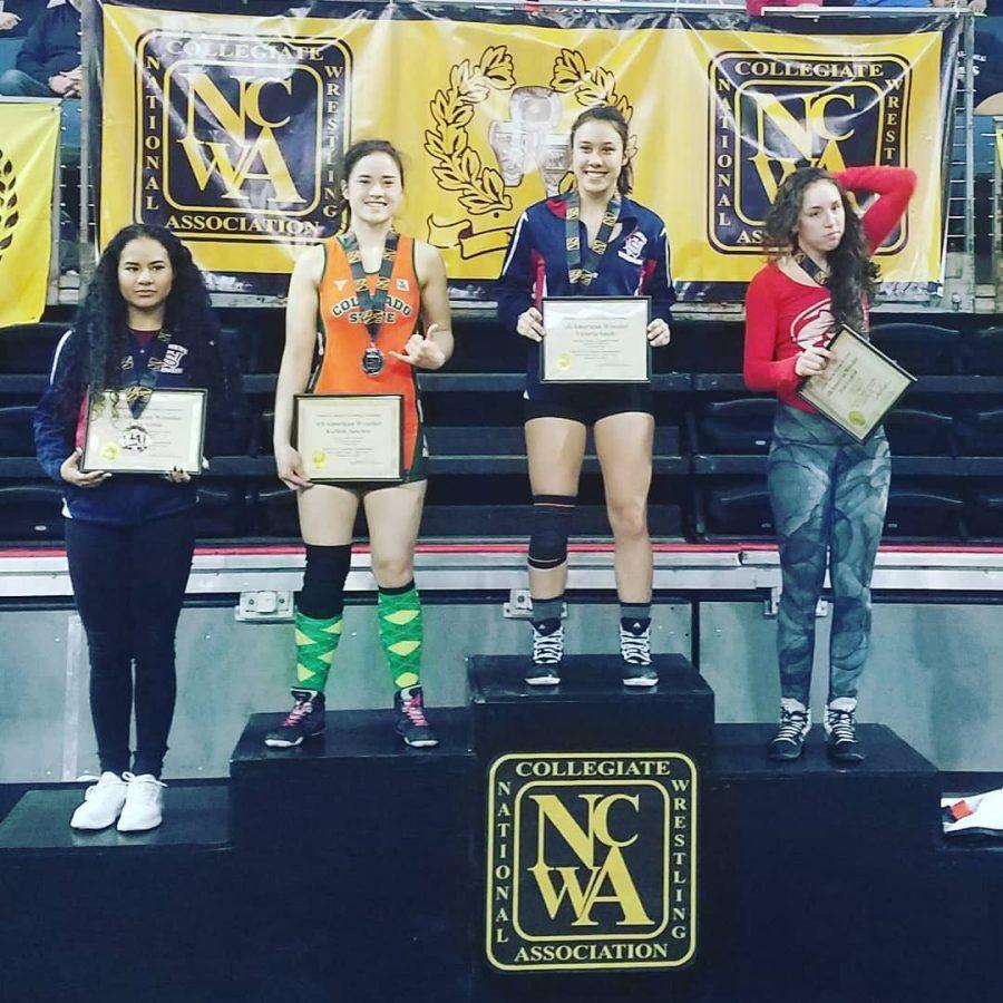 KaMele Sanchez (orange) stands on the podium after her second-place finish in the NCWA National Tournament. Sanchez earned her second All-American recognition. (Photo courtesy of CSU Athletics)