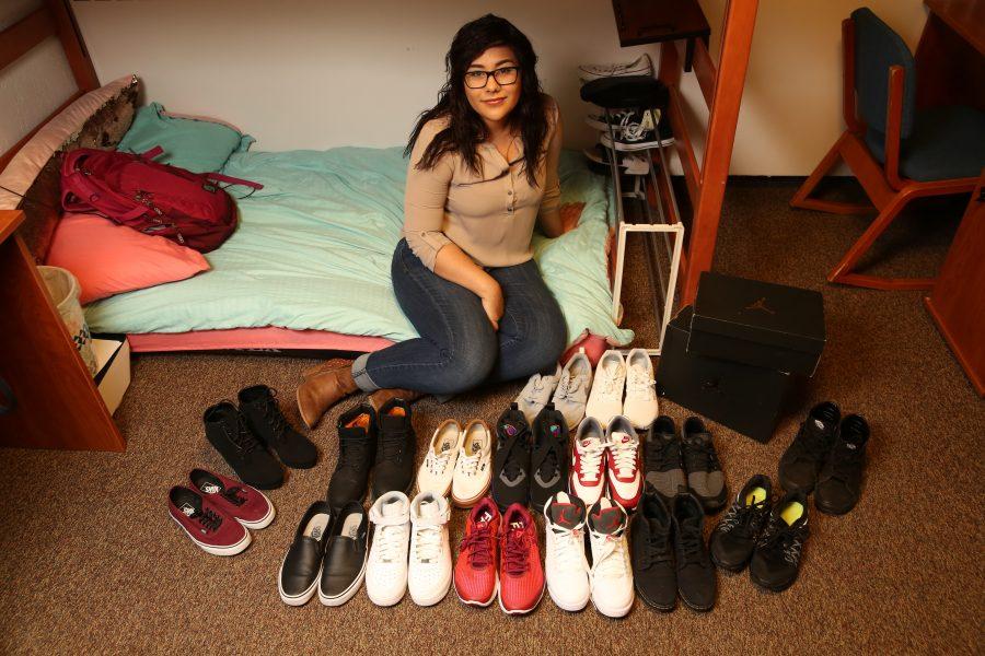 Colorado State University freshman Ashly Berumen poses for a portrait with her shoe collection inside her dorm room on March 6. Berumen is an avid shoe collector and she estimates she has roughly 75 pairs total, and is planning on adding to her collection.  (Forrest Czarnecki | The Collegian)