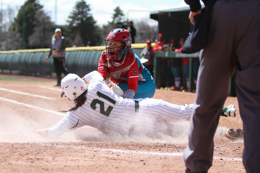 Junior Lauren Buchanan slides into home plate to score during the Rams third game against the University of New Mexico on Sunday, April 8. The Rams beat the Lobos 12-4. (Ashley Potts | Collegian)