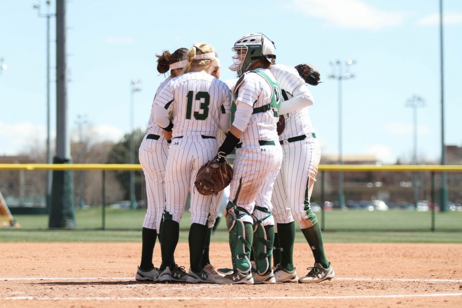 The Rams huddle in between innings of the their third game against the University of New Mexico on Sunday, April 8. The Rams beat the Lobos 12-4. (Ashley Potts | Collegian)