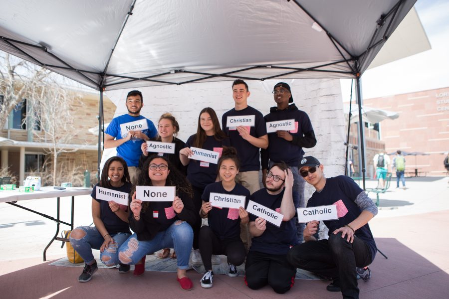 One of the stations set up for Better Together day had students take photos holding props in addition to cards with their religious identities on them in order to illustrate the idea that different religions can coexist in the same space without conflict. (Josh Schroeder | Collegian)