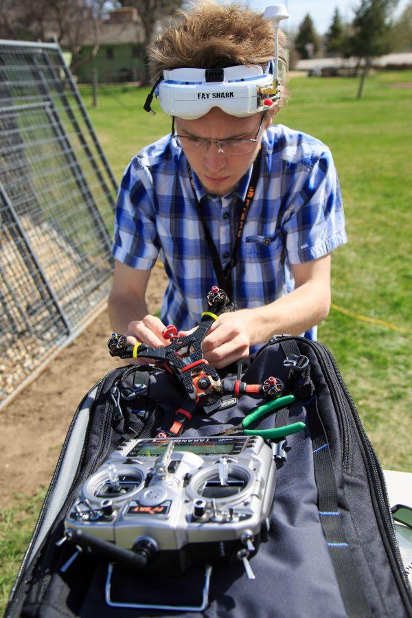 Chase Mallory, a physics major at CSU, makes final adjustments to his home-built quadcopter before flying it around FoCo FPVs drone racing track. (Davis Bonner | Collegian)
