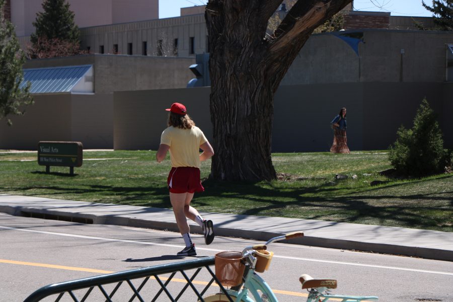 Reece Melton as he continues his run to the plaza with fellow Alpha Gamma Pho members close behind. (Devin Cornelius | Collegian)