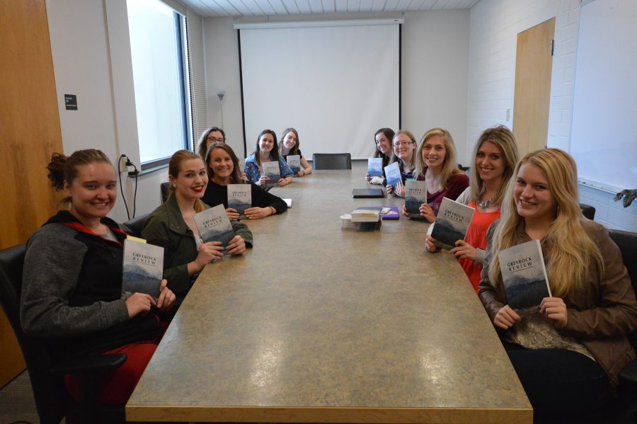 The authors of the GreyRock Review hold up their book. (Mackenzie Pinn | Collegian)