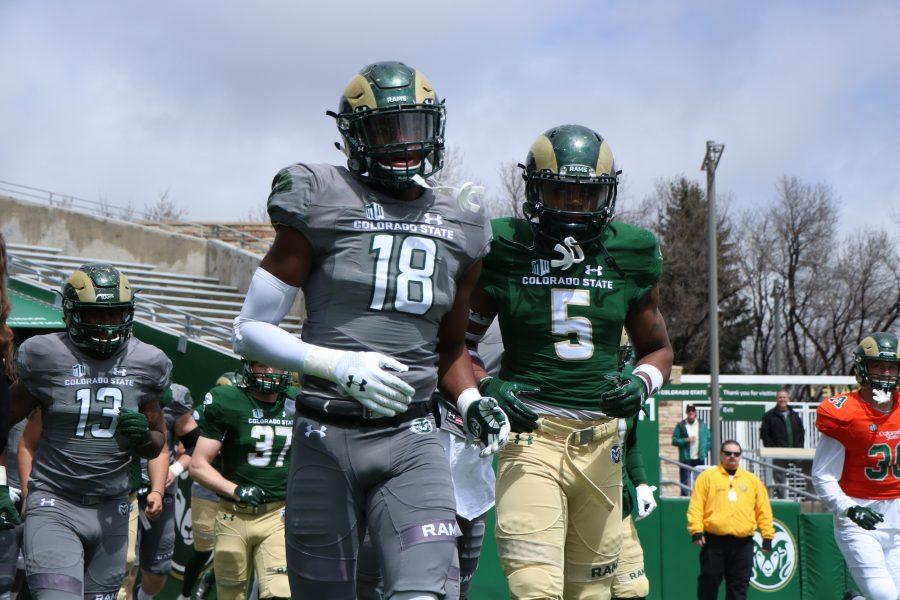 Marvin Kinsey JR and Braylin Scott run out on to the field before the spring game (Devin Cornelius | Collegian)